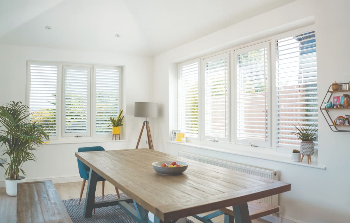 Bifold Tracked Window Shutters installed on a corner patio door